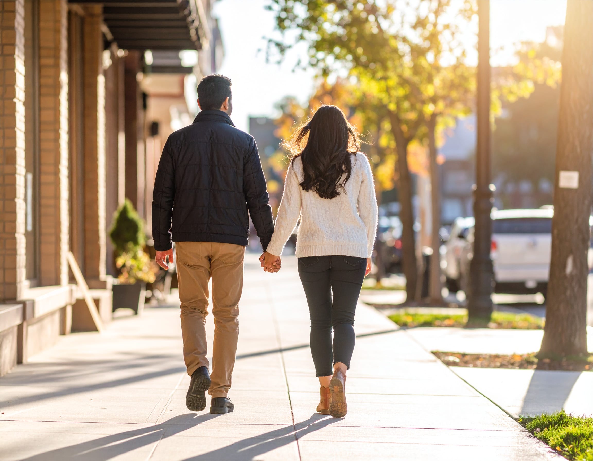 Couple walking down a sidewalk on main street-Ontario