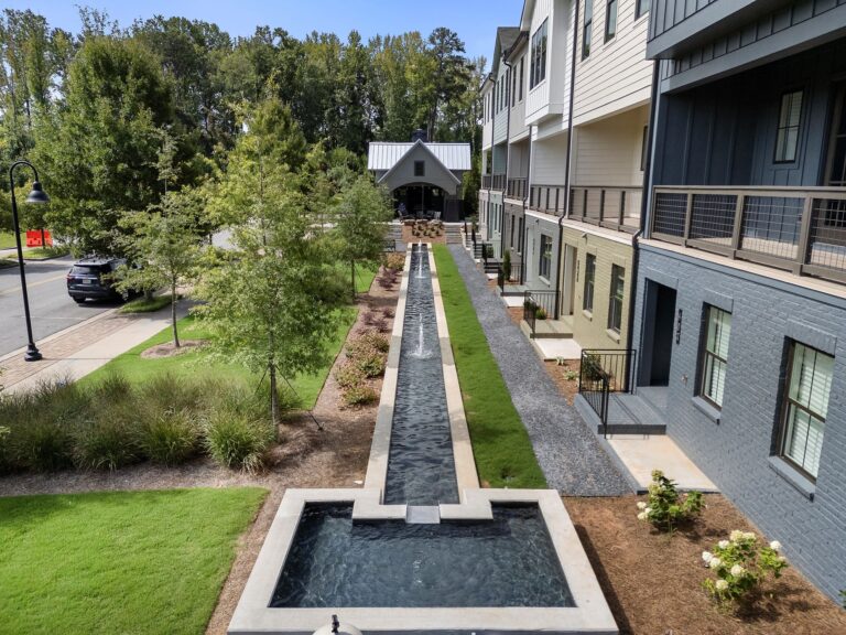 Landscaped garden with narrow fountain and outdoor seating at Empire Argosy, Alpharetta